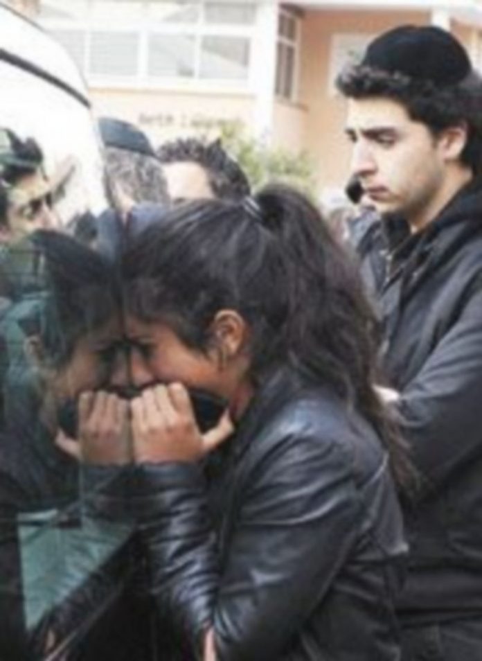 Un asesino frío y muy cruel Una mujer llora sobre uno de los coches fúnebres. / Reuters